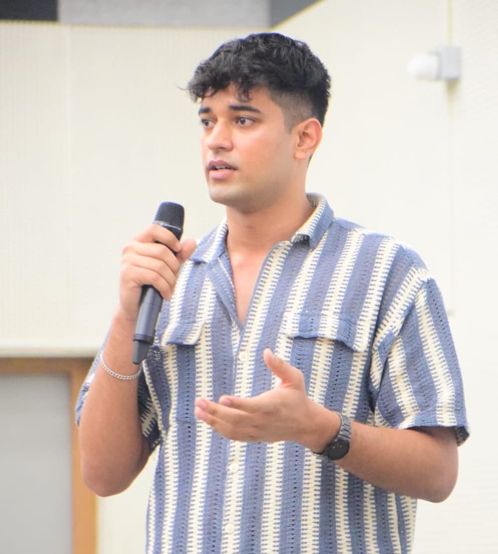 On the mic — hosting and energising student events.